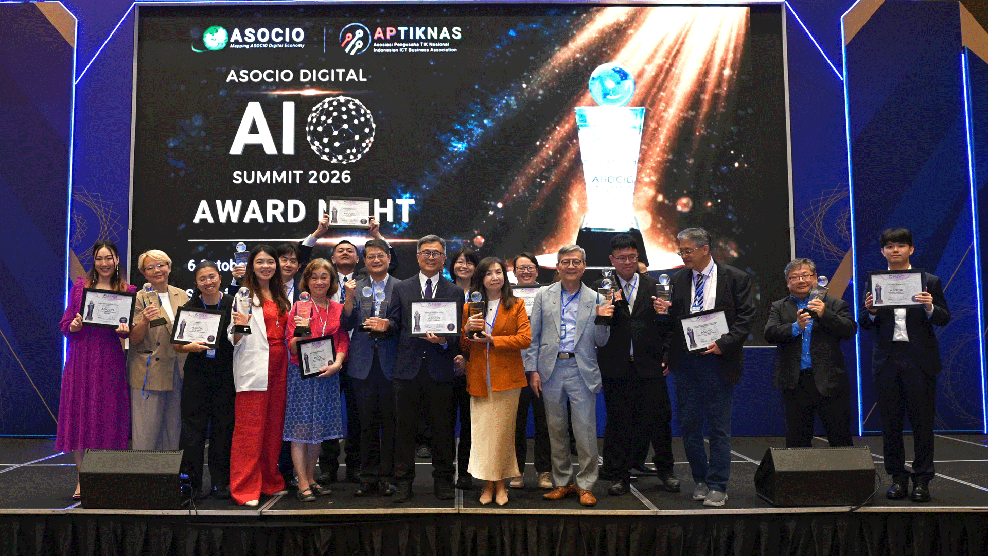 Taiwan award recipients at the 2026 ASOCIO Digital & AI Summit in Jakarta, holding trophies and certificates on stage.